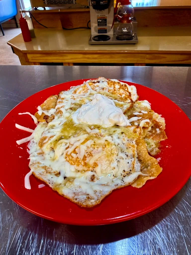 Chilaquiles with eggs, cheese, salsa verde, and sour cream