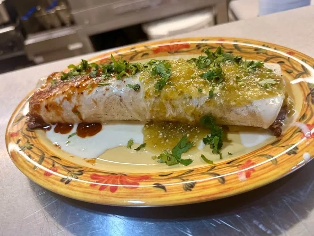 Burrito Mexicano with green salsa, red sauce, crema, and cilantro