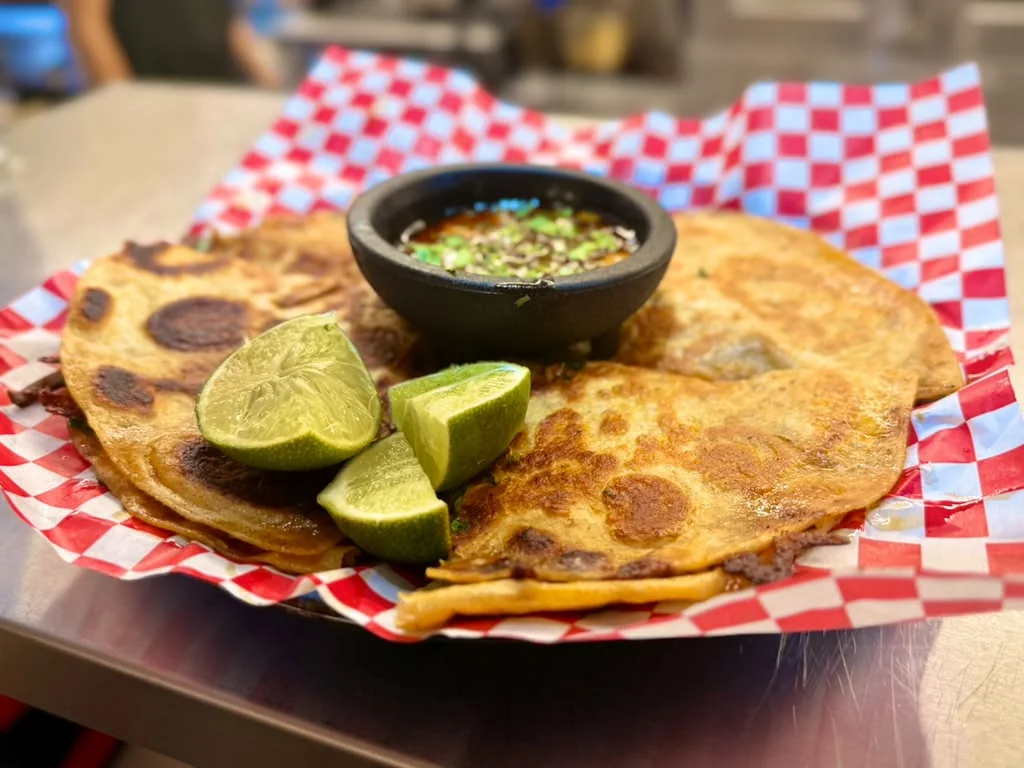 Pizza Birria served with lime and consomme